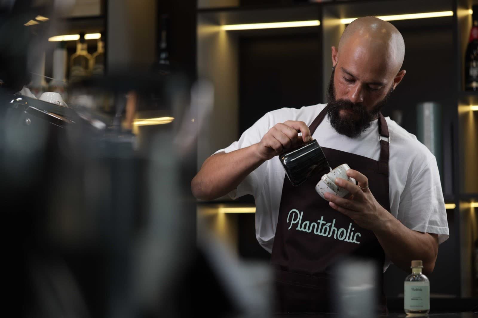 Barista pouring coffee at Plantoholic café, Palm Jumeirah