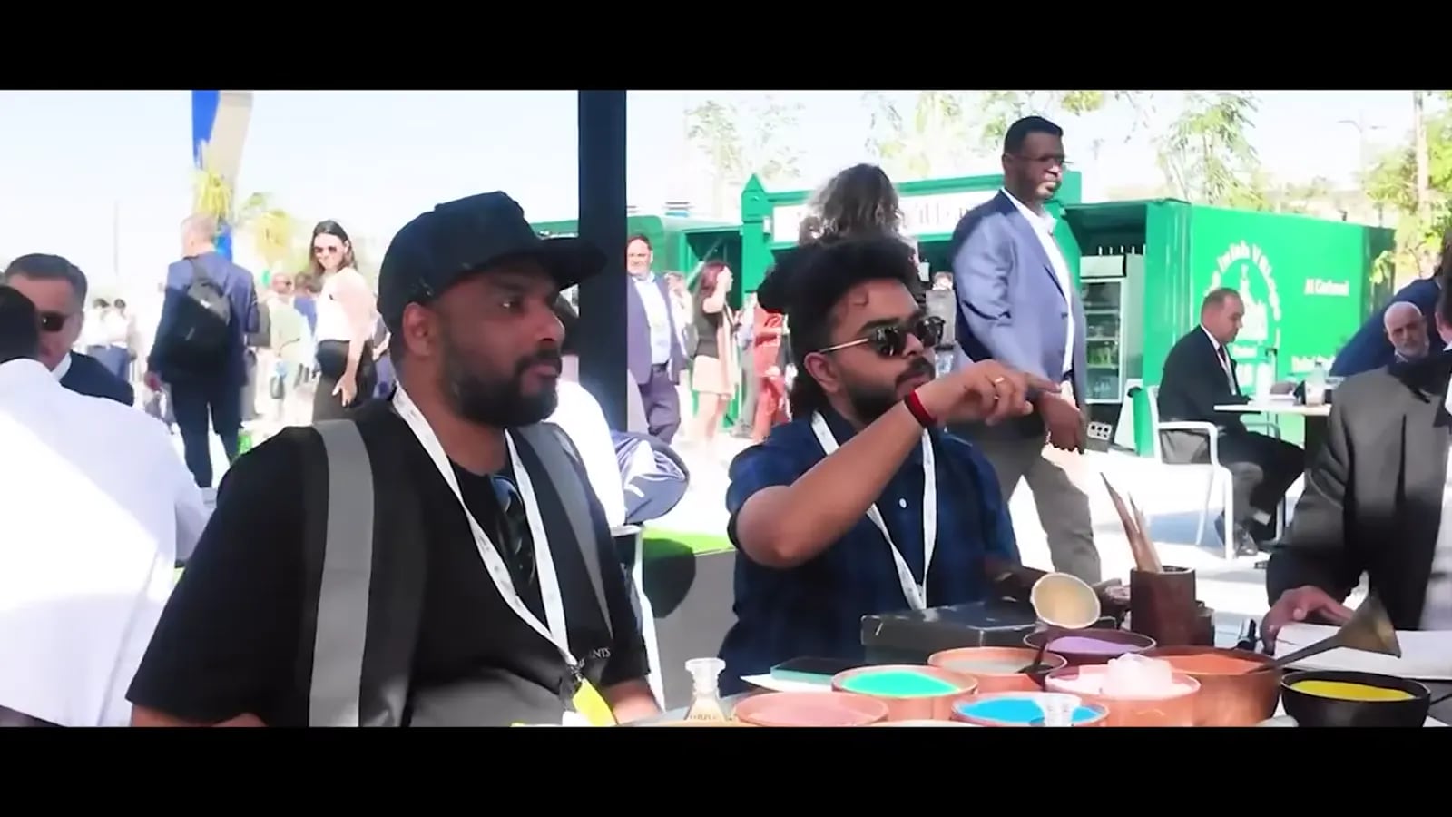 Guests at an outdoor brand activation in Dubai with branded stands