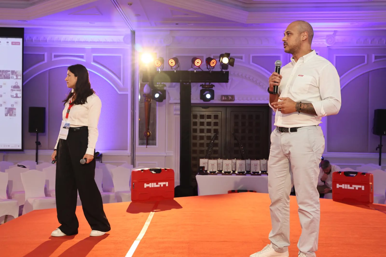 Hilti branded stage with screens, lighting and seating